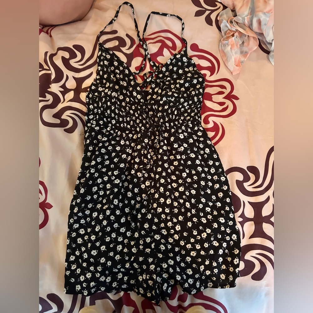 This is a black mini dress with a flower design.
